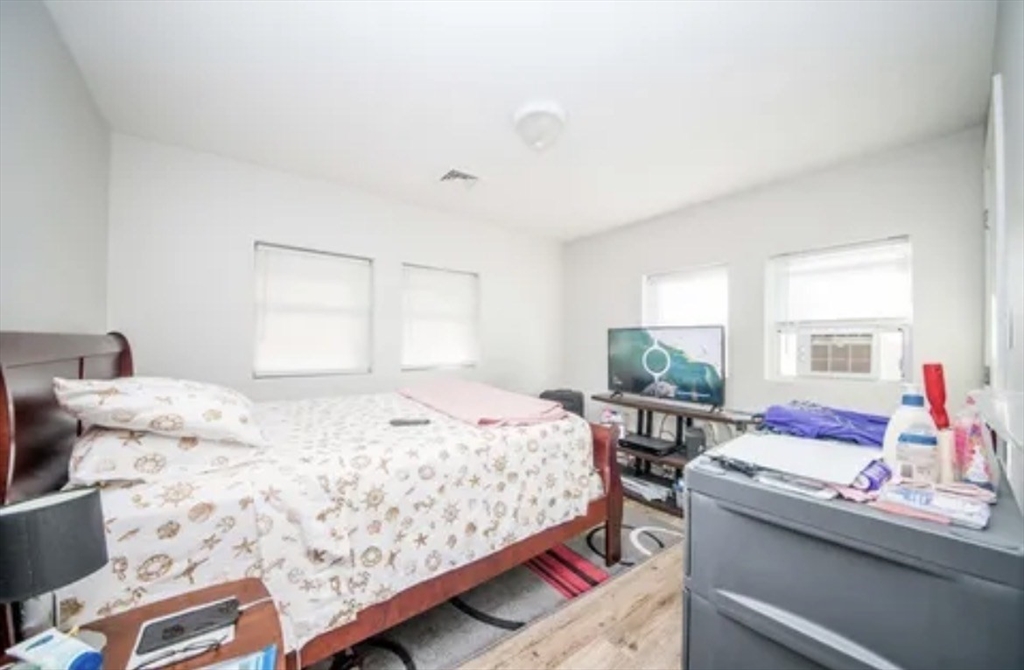 123 Sconticut Neck Road Fairhaven, MA 02719 - Photo 9 of 18 a bedroom with a bed and large window