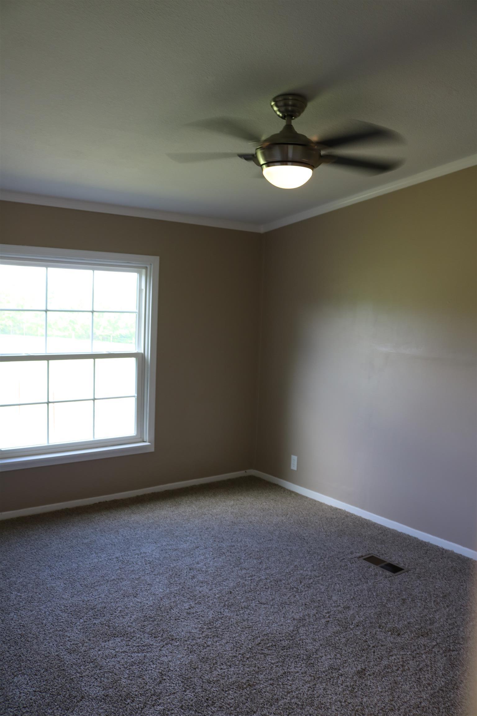 3630 Beasleys Bend Road Lebanon, TN 37087 - Photo 11 of 12 an empty room with a ceiling fan and window