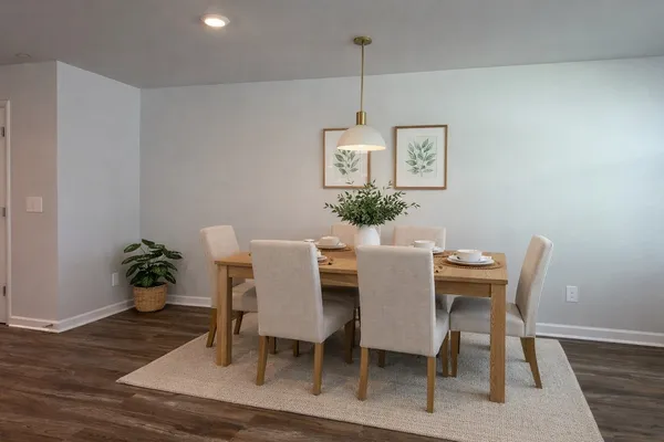 a view of a dining room with furniture wooden floor and a chandelier