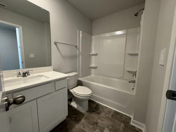 a bathroom with a sink toilet a mirror and shower