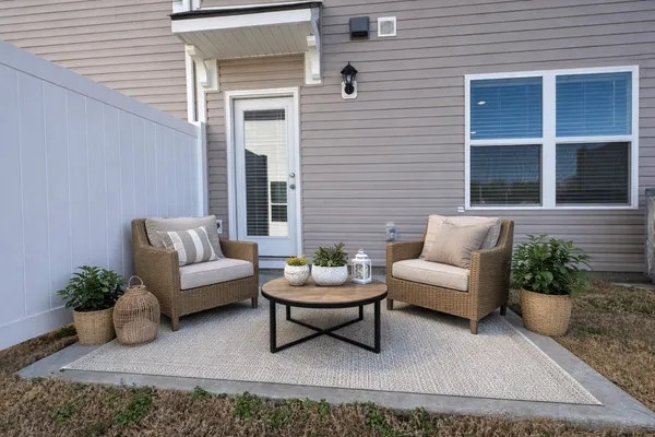 a living room with furniture potted plant and window