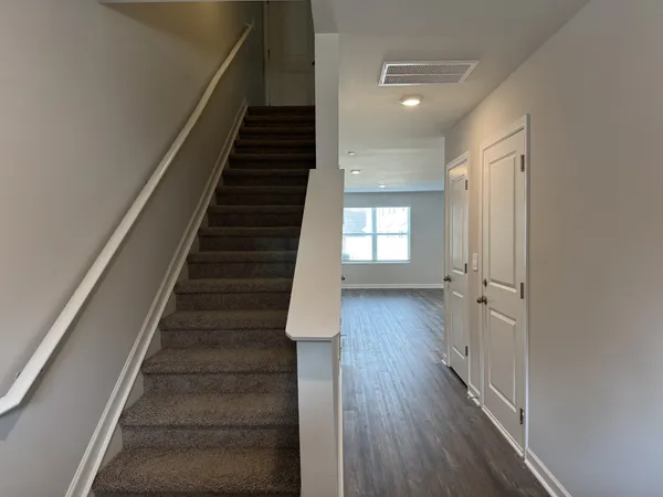 a view of entryway and hall with wooden floor