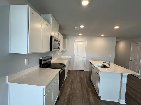 a kitchen that has a sink in it and wooden cabinets