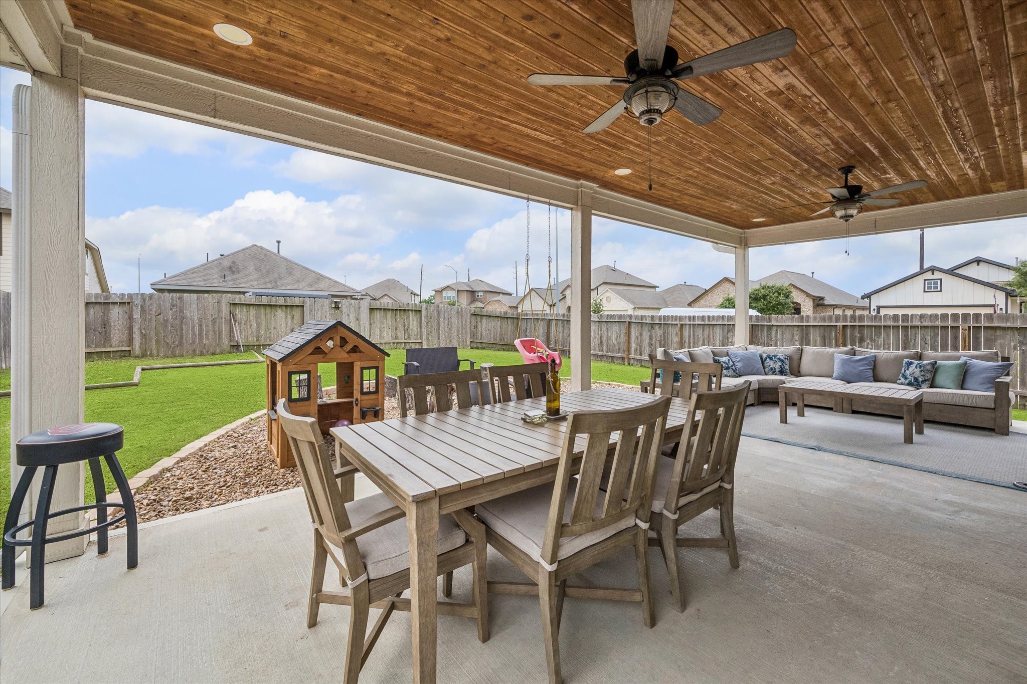 25735 Royal Catchfly Road Katy, TX 77493 - Photo 22 of 31 Upgraded and expanded oversized covered patio with fans large enough for table/chairs and a separate seating area with a sectional and coffee table, the perfect set up to entertain and enjoy time outside.