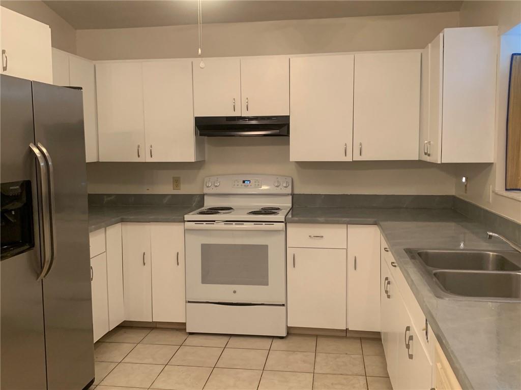 774 24th Square Vero Beach, FL 32962 - Photo 11 of 33 a kitchen with stainless steel appliances granite countertop a sink stove and refrigerator