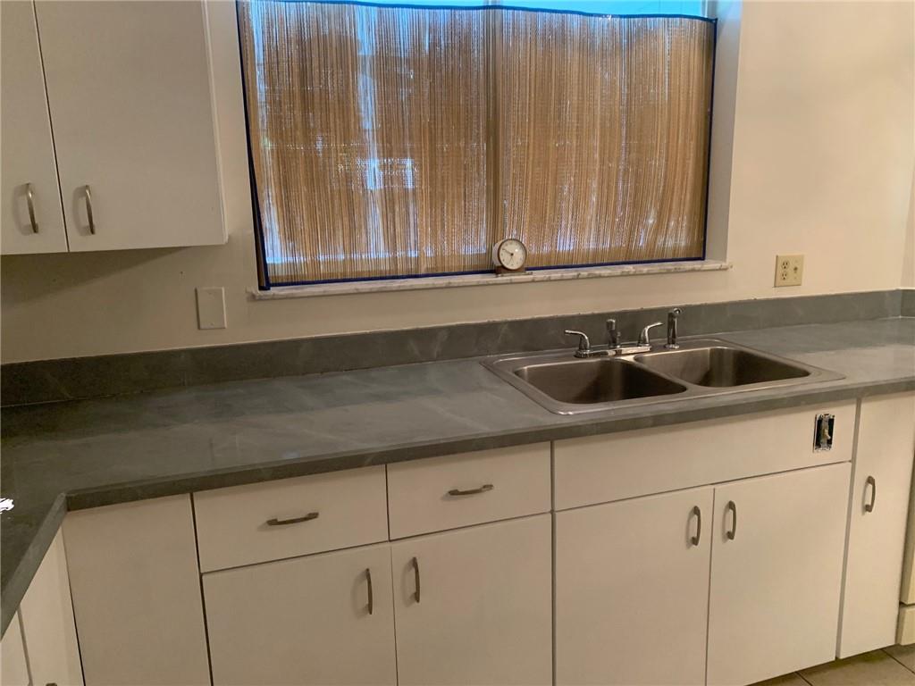 774 24th Square Vero Beach, FL 32962 - Photo 12 of 33 a kitchen with a sink and cabinets