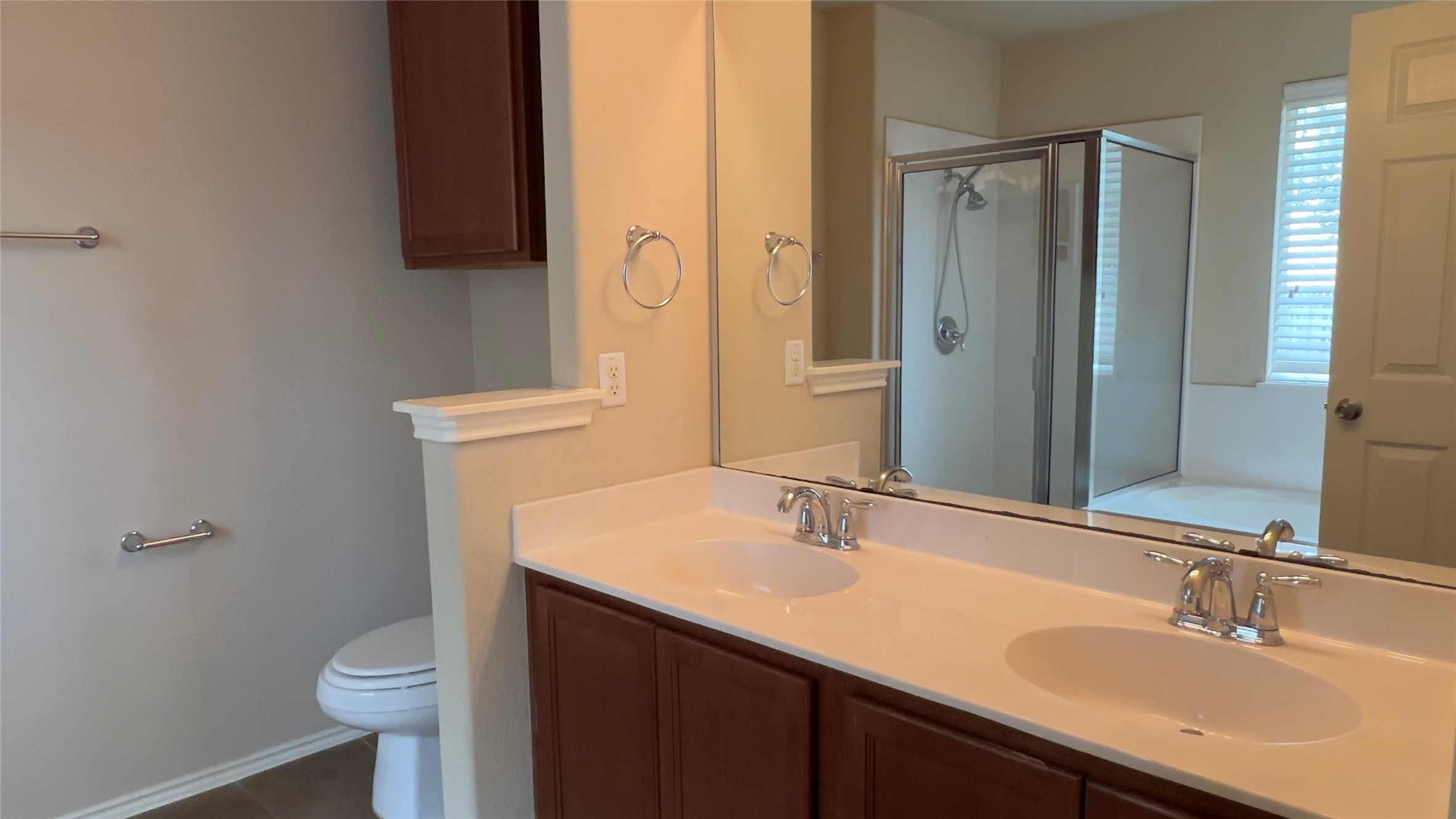 357 Nottingham Loop Kyle, TX 78640 - Photo 7 of 22 A spacious vanity with dual sinks anchors this well-appointed master bathroom setup.