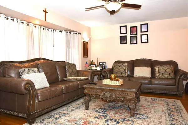 a living room with furniture and painting on the wall