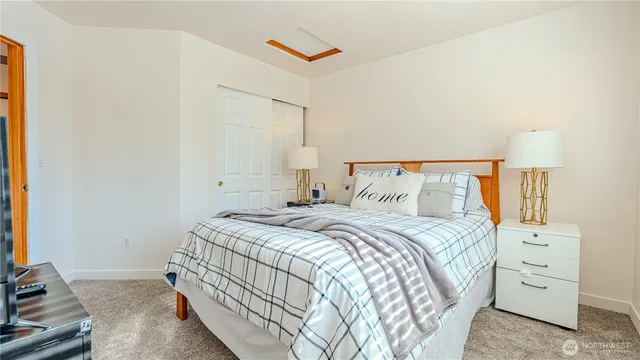 a bedroom with a bed and a night stand