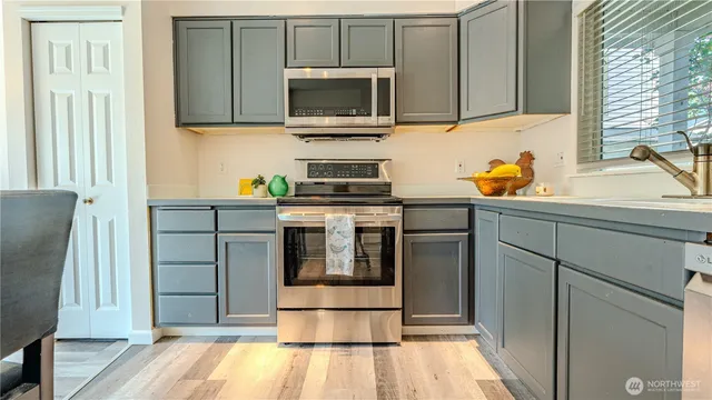 a kitchen with stainless steel appliances granite countertop a stove a sink and a refrigerator