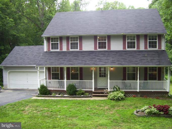 85 Walnut Creek Road Huntingtown, MD 20639 - Photo 1 of 19 a house view with a garden space