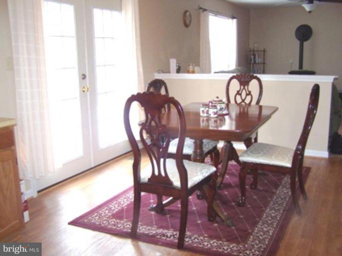 85 Walnut Creek Road Huntingtown, MD 20639 - Photo 2 of 19 a view of a dining room with furniture and wooden floor