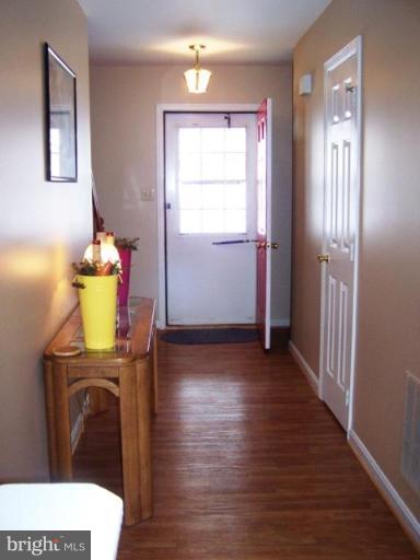 85 Walnut Creek Road Huntingtown, MD 20639 - Photo 17 of 19 a view of a room with wooden floor windows and wardrobe