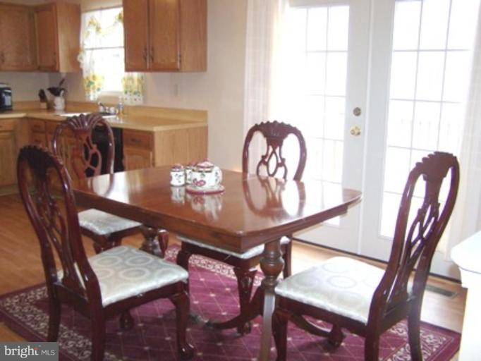 85 Walnut Creek Road Huntingtown, MD 20639 - Photo 3 of 19 a view of a dining room with furniture and window