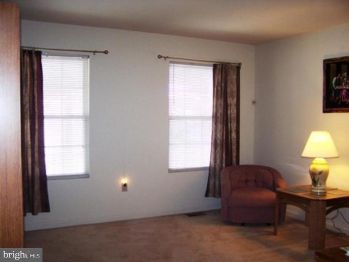 85 Walnut Creek Road Huntingtown, MD 20639 - Photo 4 of 19 a lamp and a window in a room