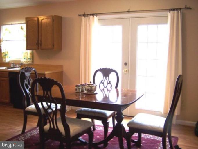 85 Walnut Creek Road Huntingtown, MD 20639 - Photo 9 of 19 a view of a dining room with furniture and chandelier