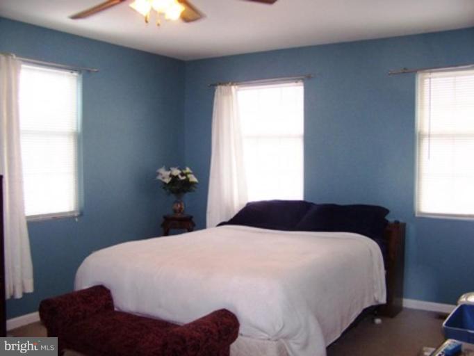 85 Walnut Creek Road Huntingtown, MD 20639 - Photo 10 of 19 a bedroom with a bed and a window
