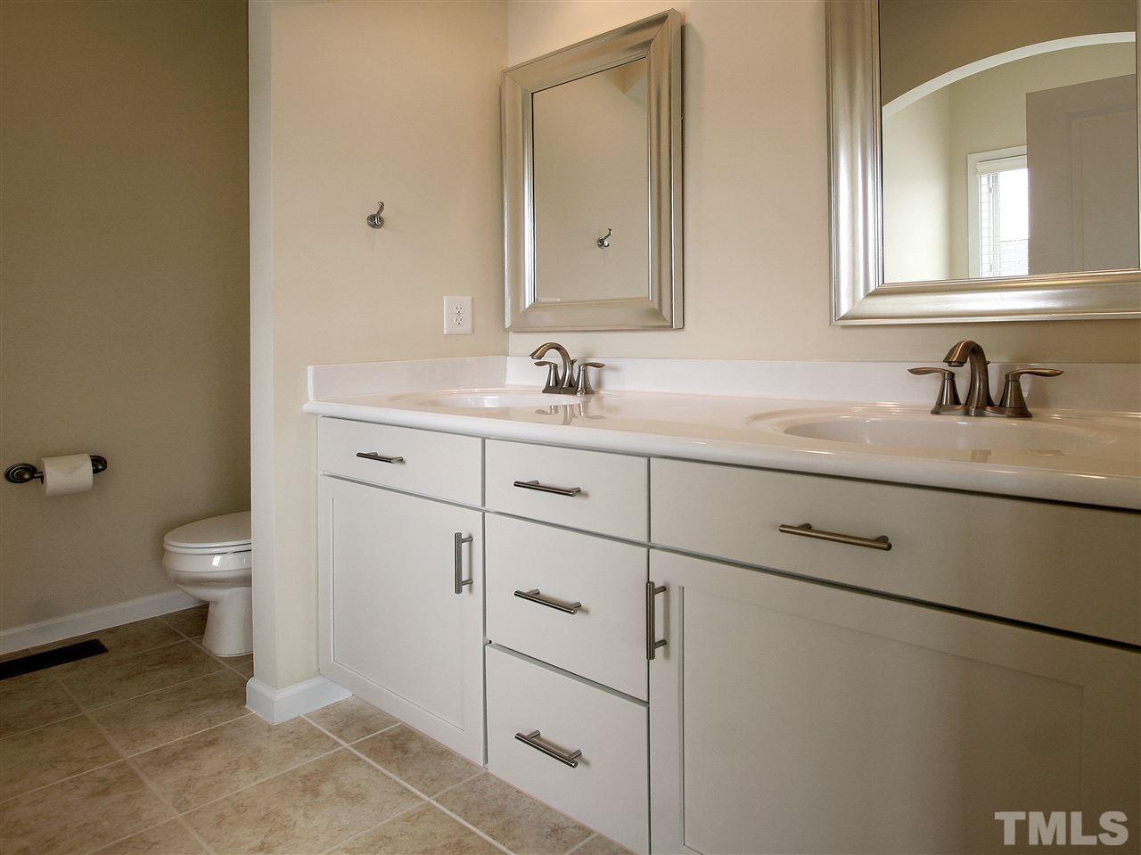 1517 Rodessa Run Raleigh, NC 27607 - Photo 13 of 25 a bathroom with a toilet sink and mirror