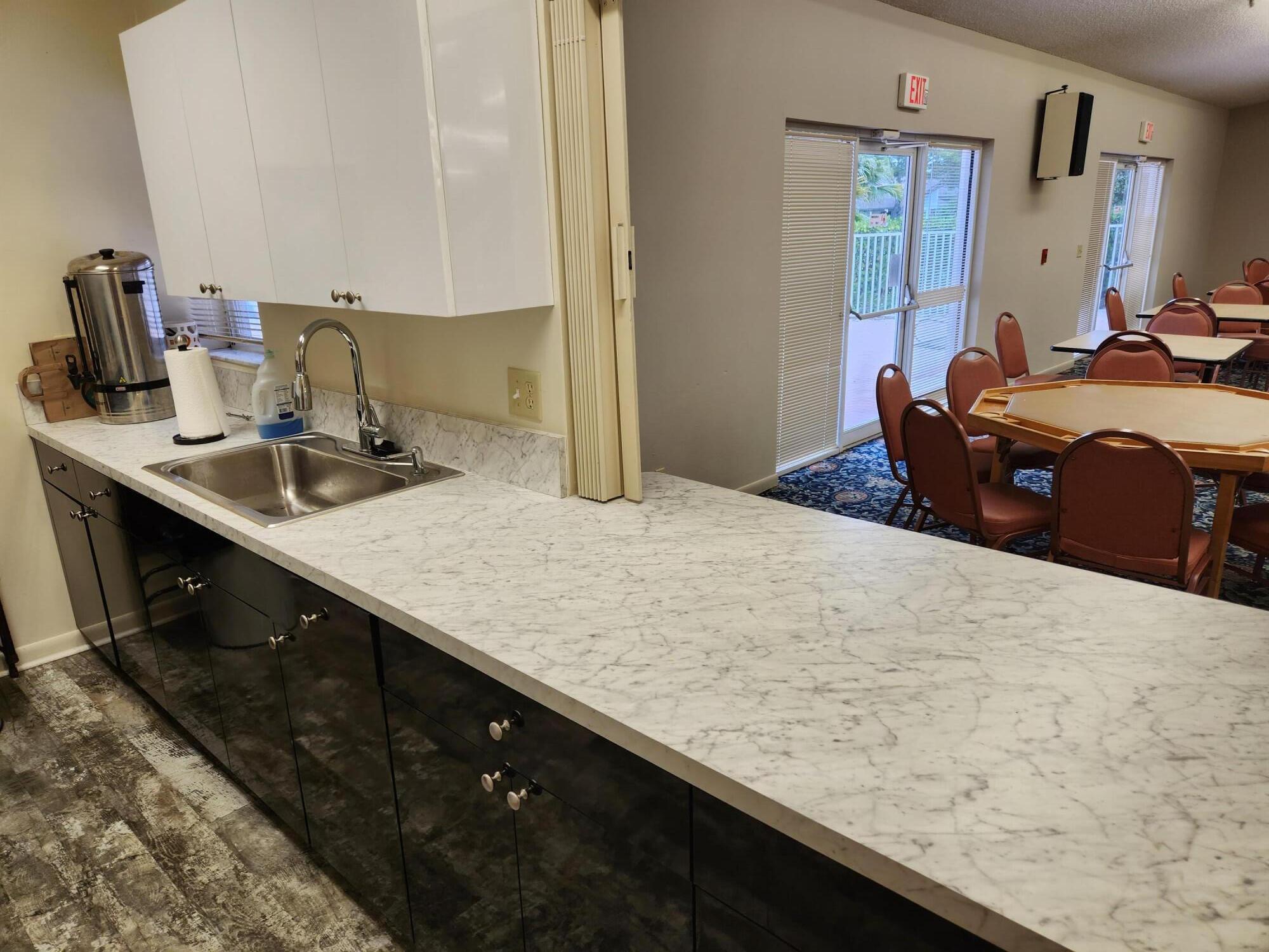 18541 Cherborg Drive, Unit D Boca Raton, FL 33496 - Photo 24 of 36 a bedroom with a bed and a dresser