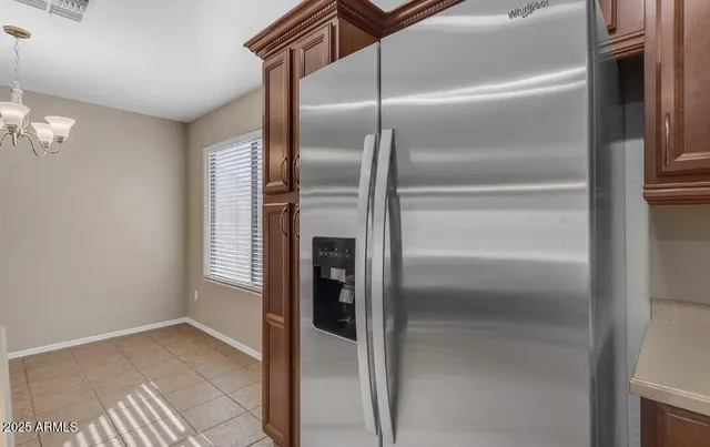 a kitchen with a refrigerator and more cabinets