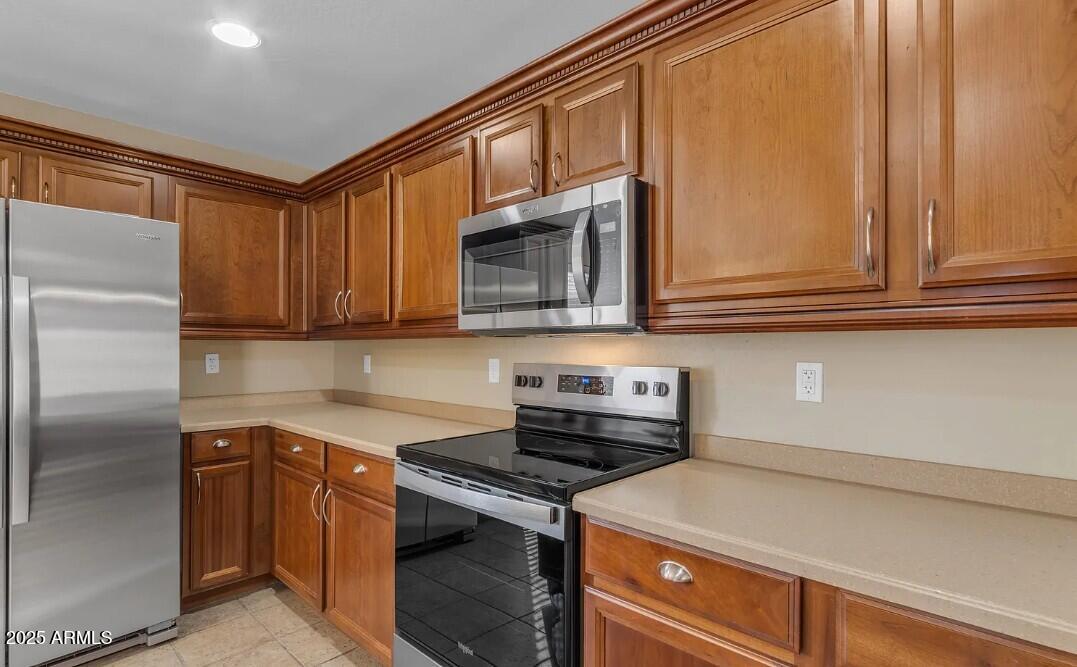 2199 West Tanner Ranch Road San Tan Valley, AZ 85144 - Photo 12 of 38 a kitchen with stainless steel appliances granite countertop a refrigerator and a stove top oven
