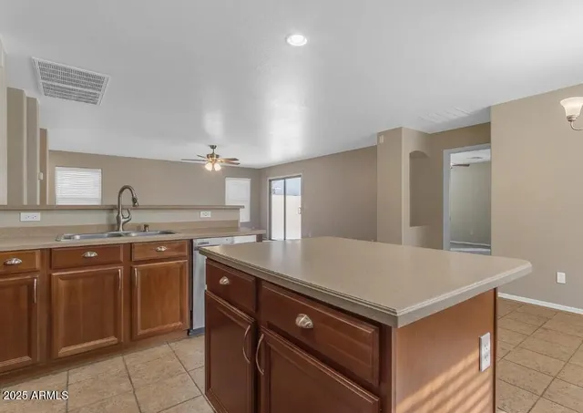 a kitchen with a sink cabinets and wooden floor