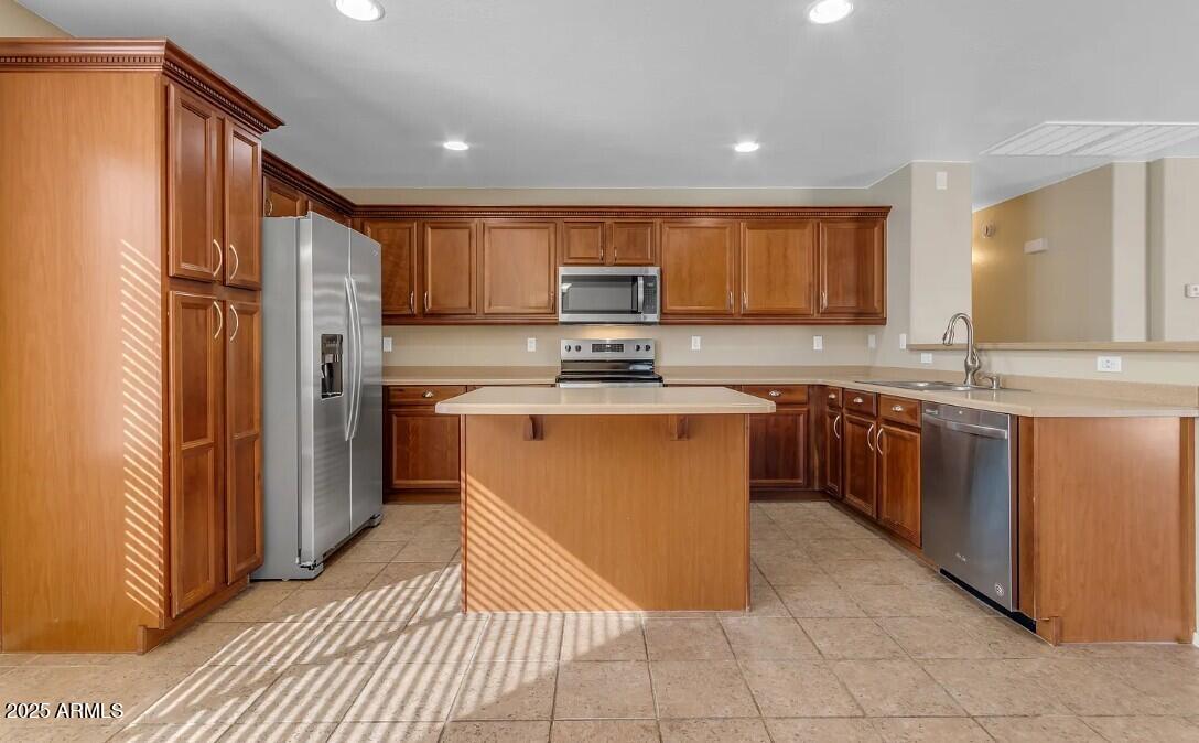 2199 West Tanner Ranch Road San Tan Valley, AZ 85144 - Photo 14 of 38 a kitchen with stainless steel appliances granite countertop a stove top oven a sink and a refrigerator