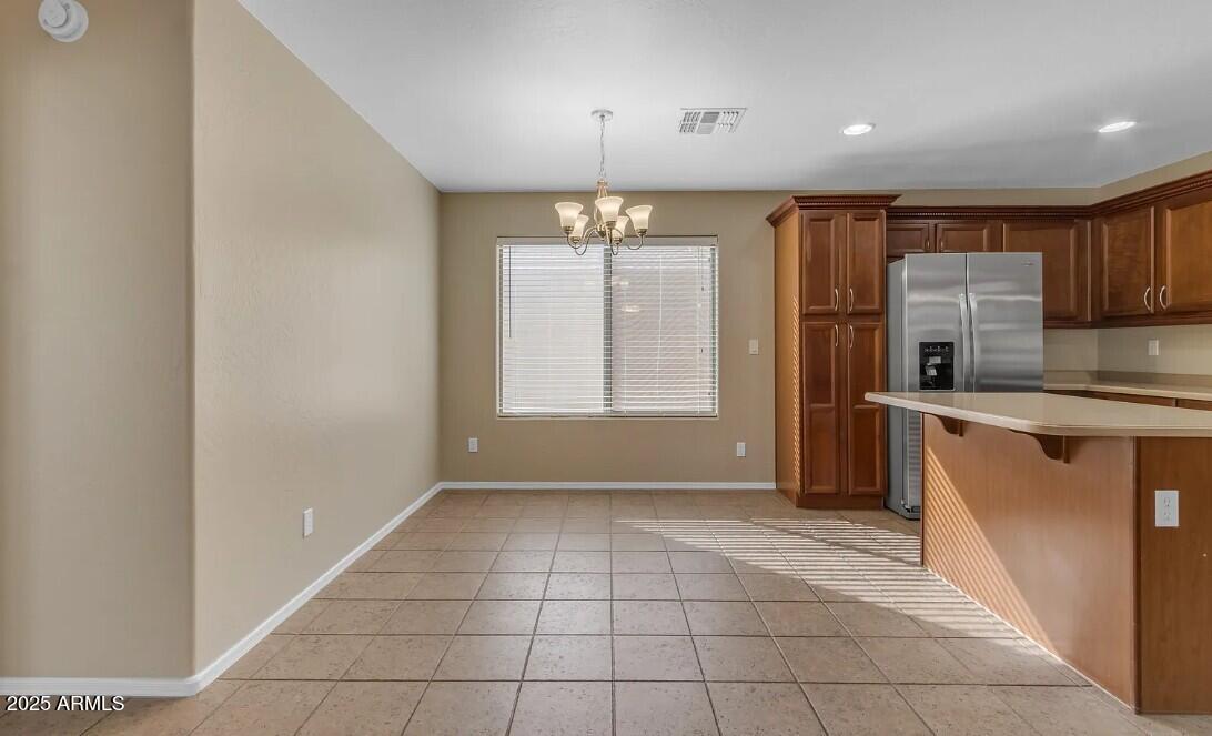 2199 West Tanner Ranch Road San Tan Valley, AZ 85144 - Photo 17 of 38 a view of kitchen with granite countertop cabinets and refrigerator