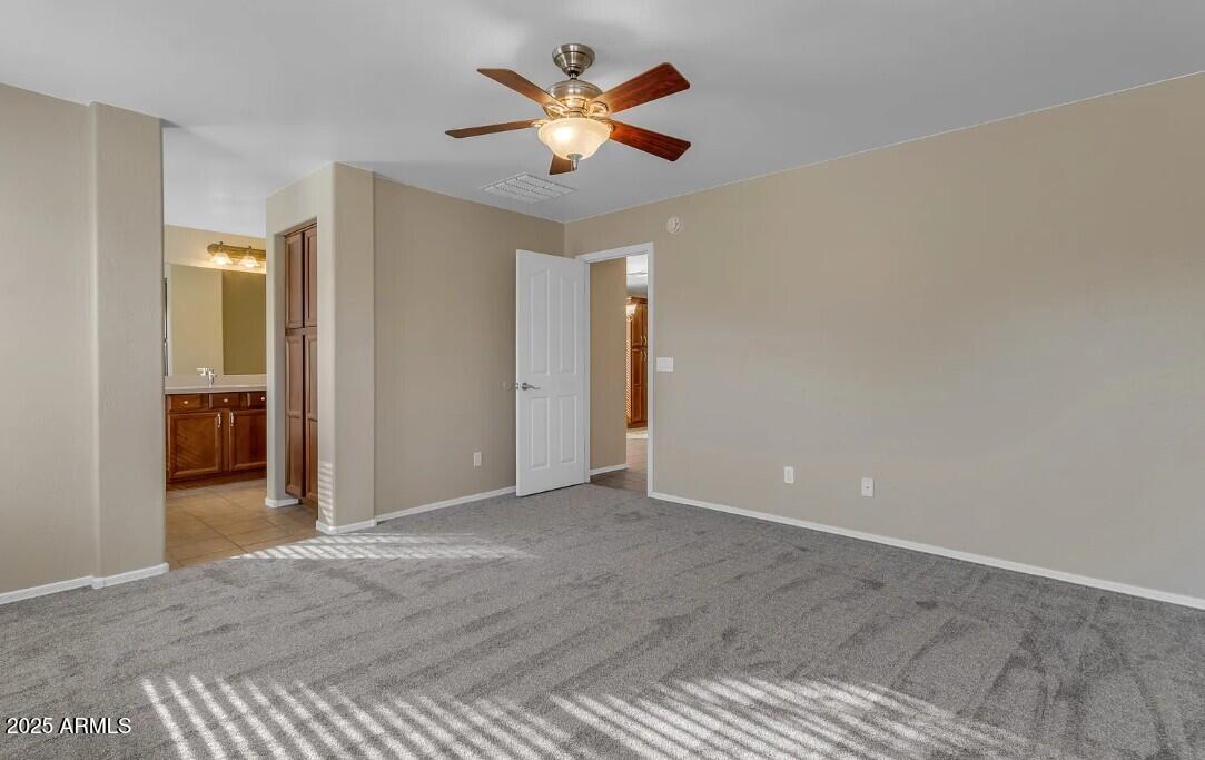 2199 West Tanner Ranch Road San Tan Valley, AZ 85144 - Photo 21 of 38 an empty room with closet and fan