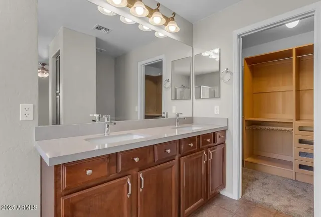 a bathroom with a sink a vanity and a large mirror