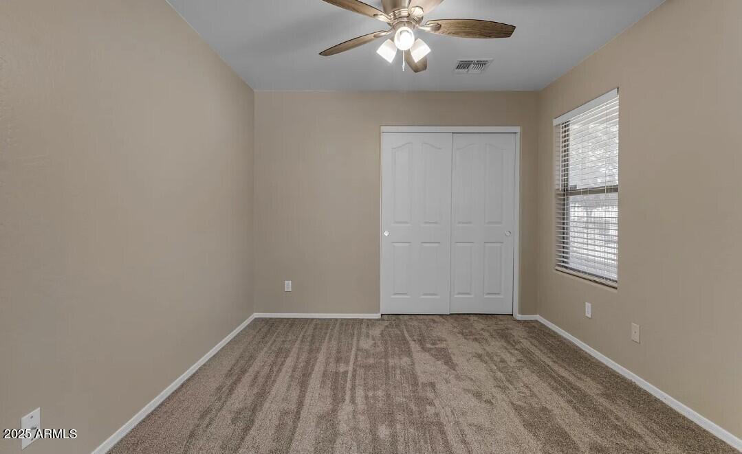 2199 West Tanner Ranch Road San Tan Valley, AZ 85144 - Photo 28 of 38 wooden floor in an empty room with a window
