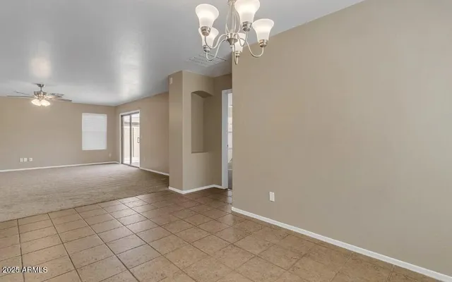 a view of a chandelier fan and entryway