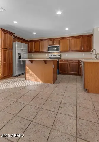 a large kitchen with stainless steel appliances lots of counter top space and cabinets
