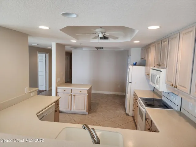 a kitchen with a sink appliances and cabinets