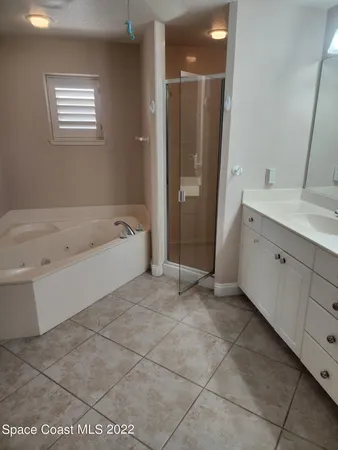 a spacious bathroom with a bathtub and a sink