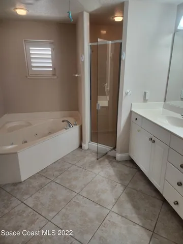 a spacious bathroom with a bathtub and a sink