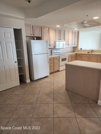 a kitchen with a stove a refrigerator and a sink