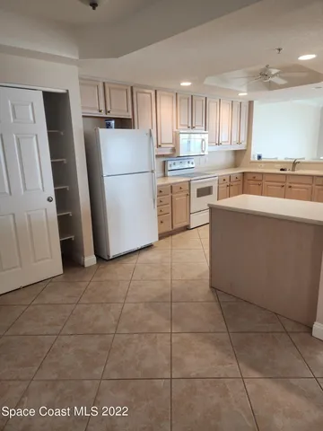 a kitchen with a stove a refrigerator and a sink