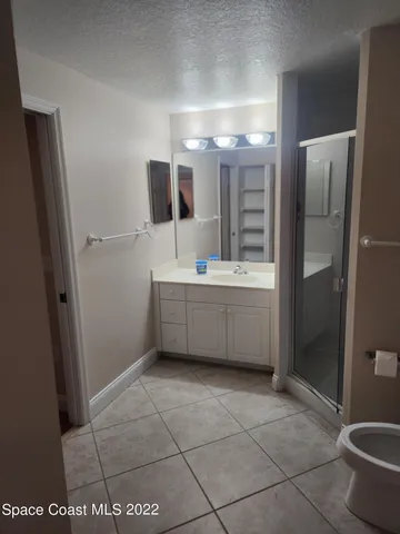 a bathroom with a sink a toilet and mirror