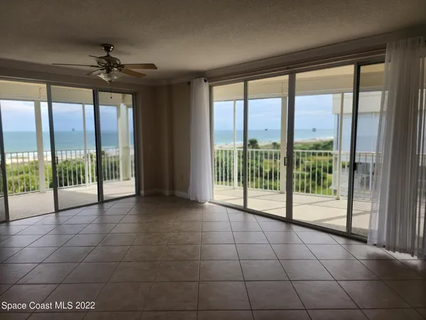 a view of an empty room with windows