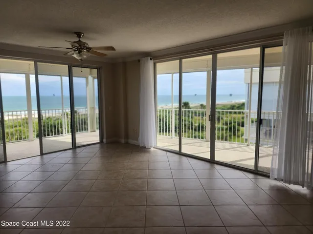 a view of an empty room with windows