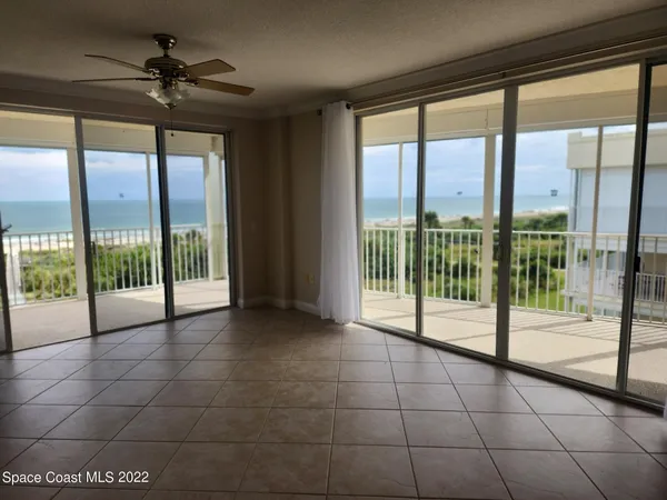 a view of a living room and balcony