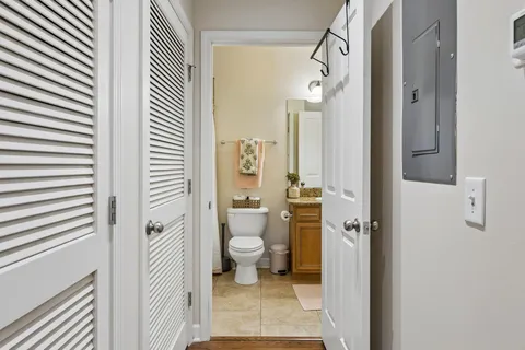 a bathroom with a granite countertop shower a toilet and a sink