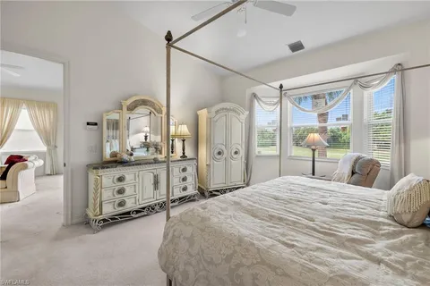 a bedroom with a large bed and a dresser