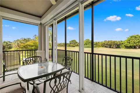 a view of a balcony with furniture and wooden floor