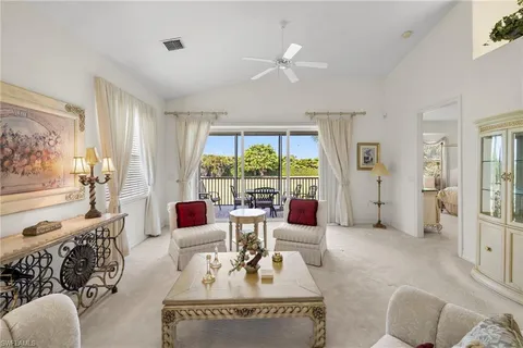 a living room with furniture and large windows