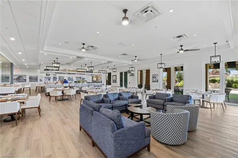 a living room with lots of furniture and view of kitchen