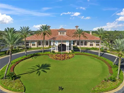 an aerial view of a house with a yard and lake view