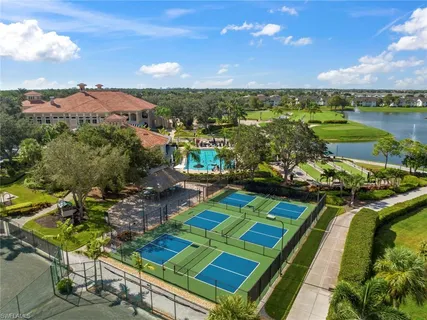 an aerial view of residential houses with outdoor space and river