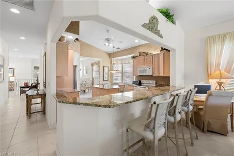 a large kitchen with a table and chairs
